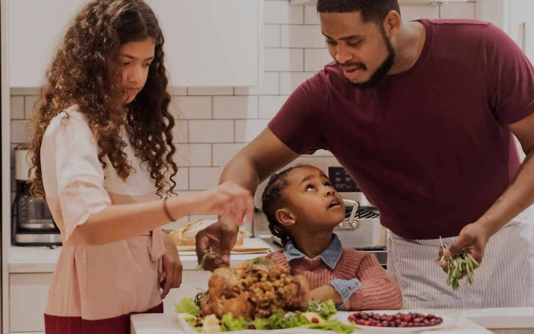 man-with-two-girls-preparing-thanksgiving-dinner