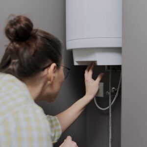 woman-looking-at-tankless-water-heater