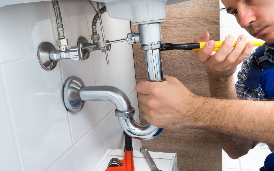 Plumber-Repairing-Kitchen-Sink