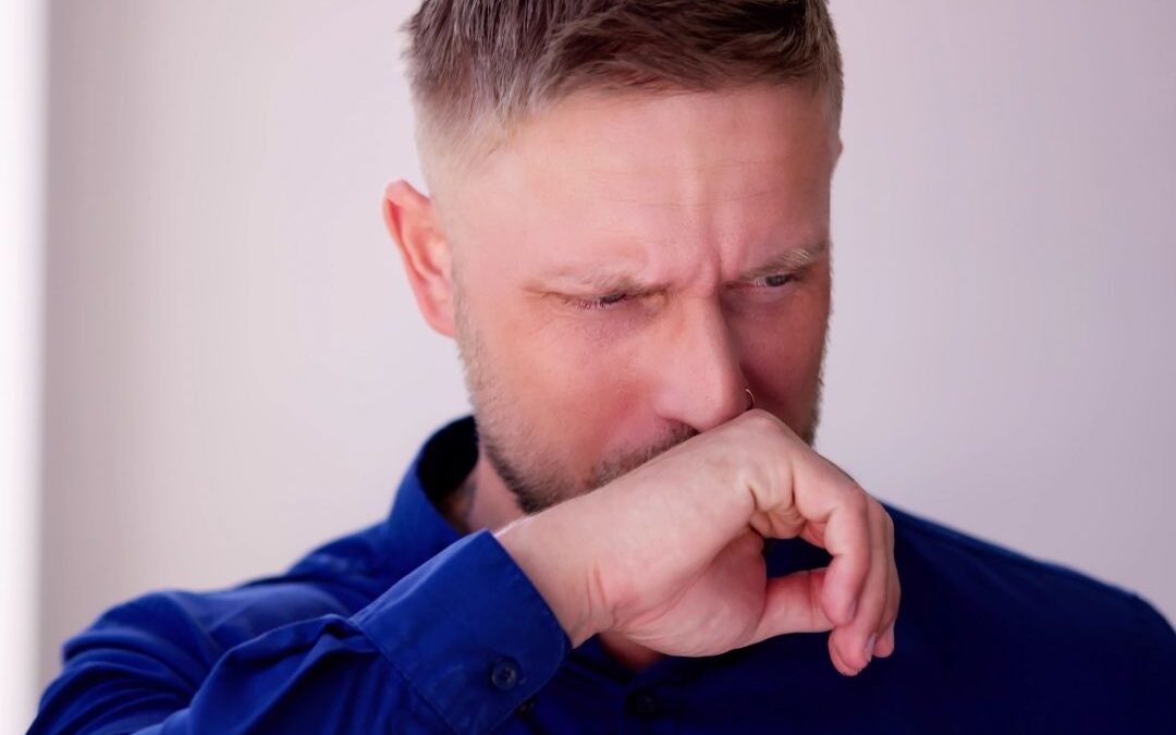 Man-Covering-Mouth-and-Nose-with-Hand