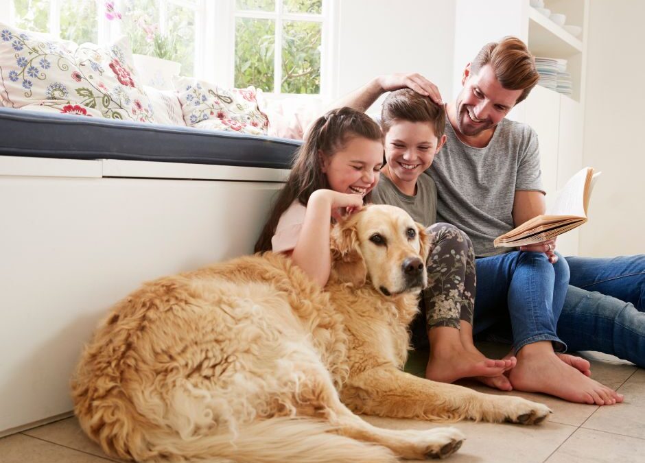 father-with-two-young-daughters-and-dog-sitting-on-floor