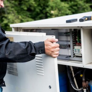 hvac-technician-removing-panel-from-hvac-unit hvac-technician-removing-panel-from-hvac-unit