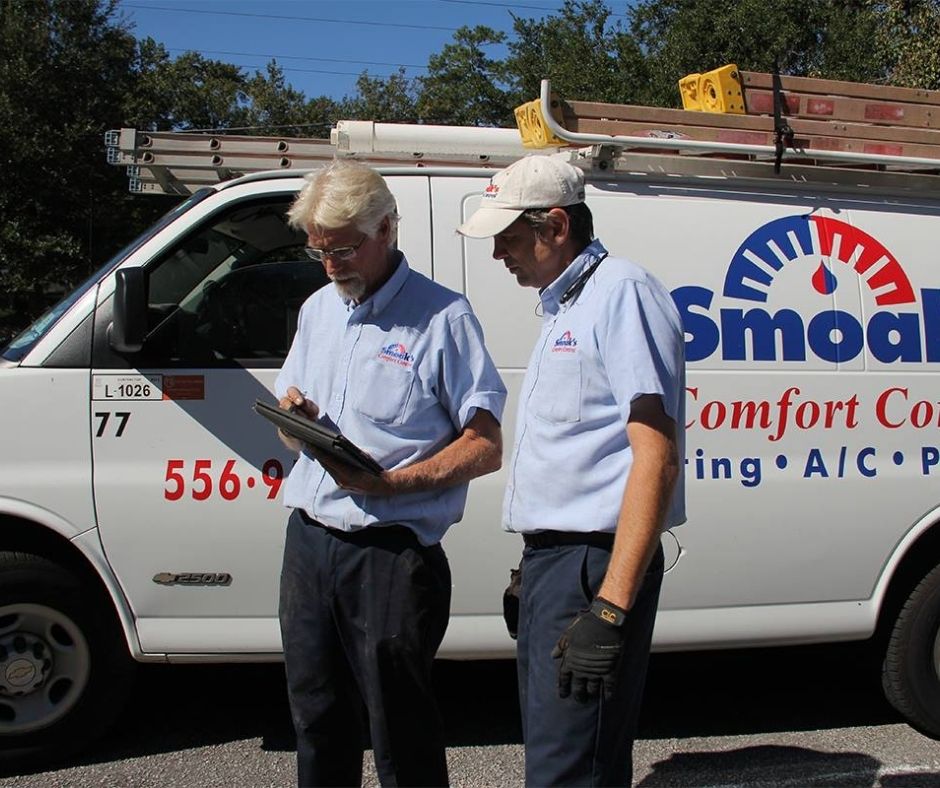 HVAC-Technicians-Standing-and-Talking-Beside-Truck