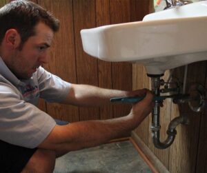 Plumber-Repairing-Bathroom-Sink