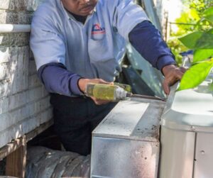 Technician-Using-a-Drill-on-a-Commercial-HVAC-Unit