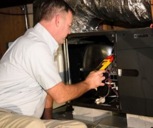 HVAC-Technician-Looking-at-Heating-System