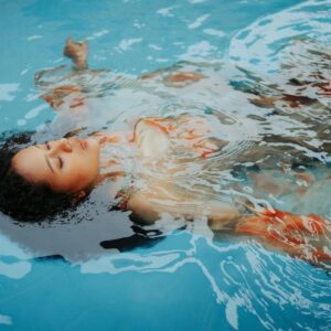 Young-Girl-Floating-on-Back-in-Pool