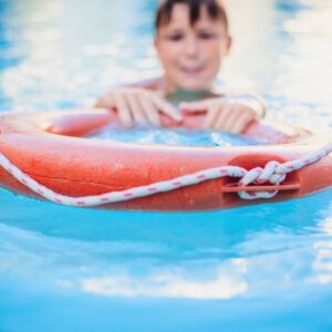 Young-Boy-Playing-with-a-Float-in-Pool