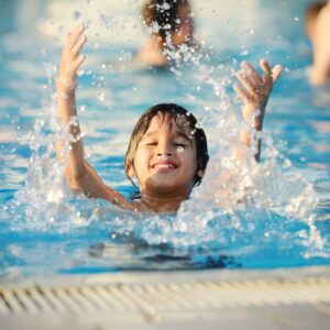 Young-Boy-Splashing-and-Playing-in-Pool